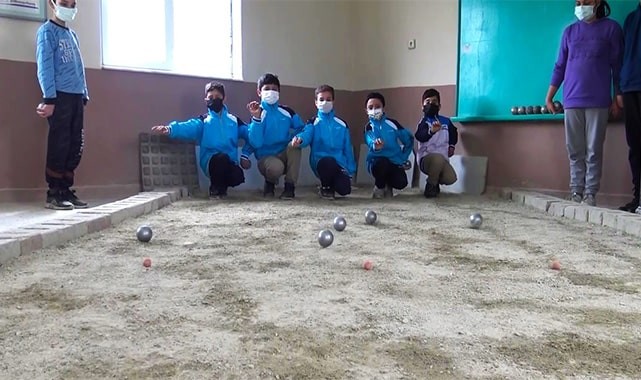 Soba üzerinde topları ısıtıp dağ köyünde bocce oynuyorlar