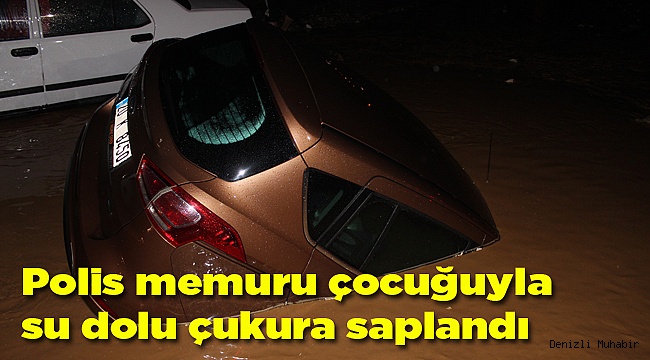 Polis memuru çocuğuyla su dolu çukura saplandı