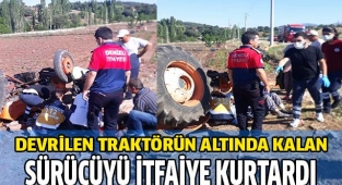 Devrilen traktörün altında kalan sürücüyü itfaiye kurtardı