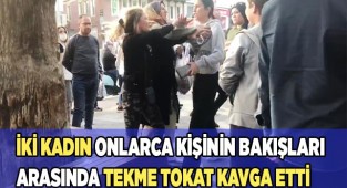 İki kadın onlarca kişinin bakışları arasında tekme tokat kavga etti