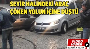 Seyir halindeki araç çöken yolun içine düştü