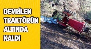 Devrilen traktörün altında kaldı