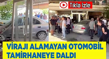 Virajı alamayan otomobil tamirhaneye daldı